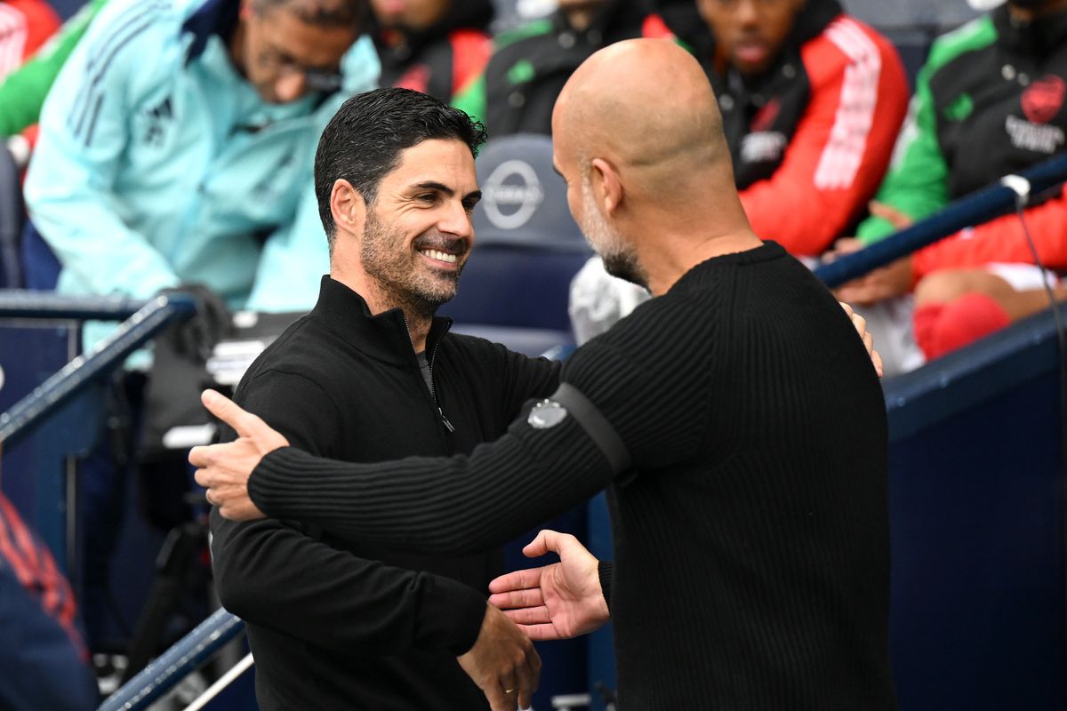 Mikel Arteta, Manager of Arsenal, embraces Josep Guardiola, Manager of Manchester City, prior to the Premier League match between Manchester City FC and Arsenal FC at Etihad Stadium on September 22, 2024 in Manchester, England