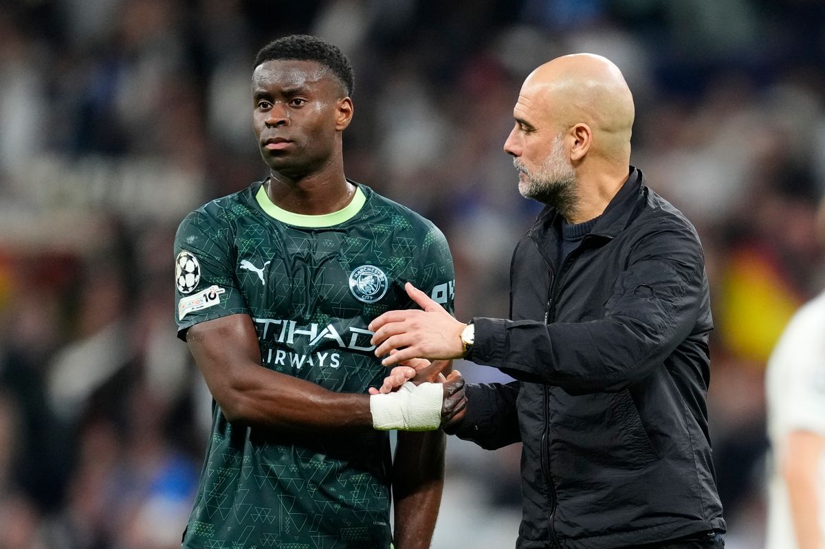Pep Guardiola head coach of Manchester City and Spain and Marc Guehi centre-back of Manchester City and Cote d'Ivoire after the UEFA Champions League 2025/26 Round of 16 First Leg match between Real Madrid CF and Manchester City FC at Estadio Santiago Bernabeu on March 11, 2026 in Madrid, Spain.