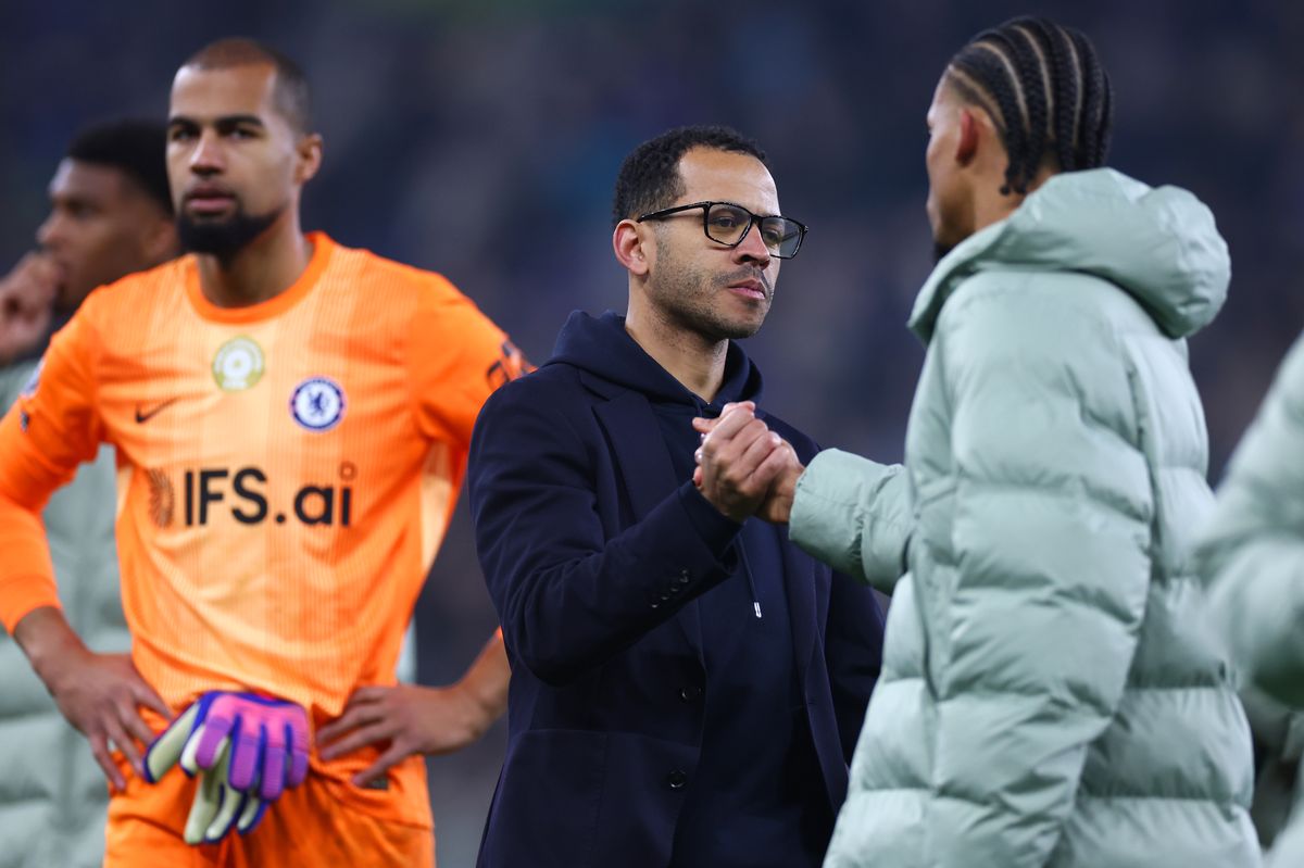 Chelsea coach Liam Rosenior shakes hands with Joao Ped at full-time following the Premier League match between Everton and Chelsea at Goodison Park on March 21, 2026 in Liverpool, England