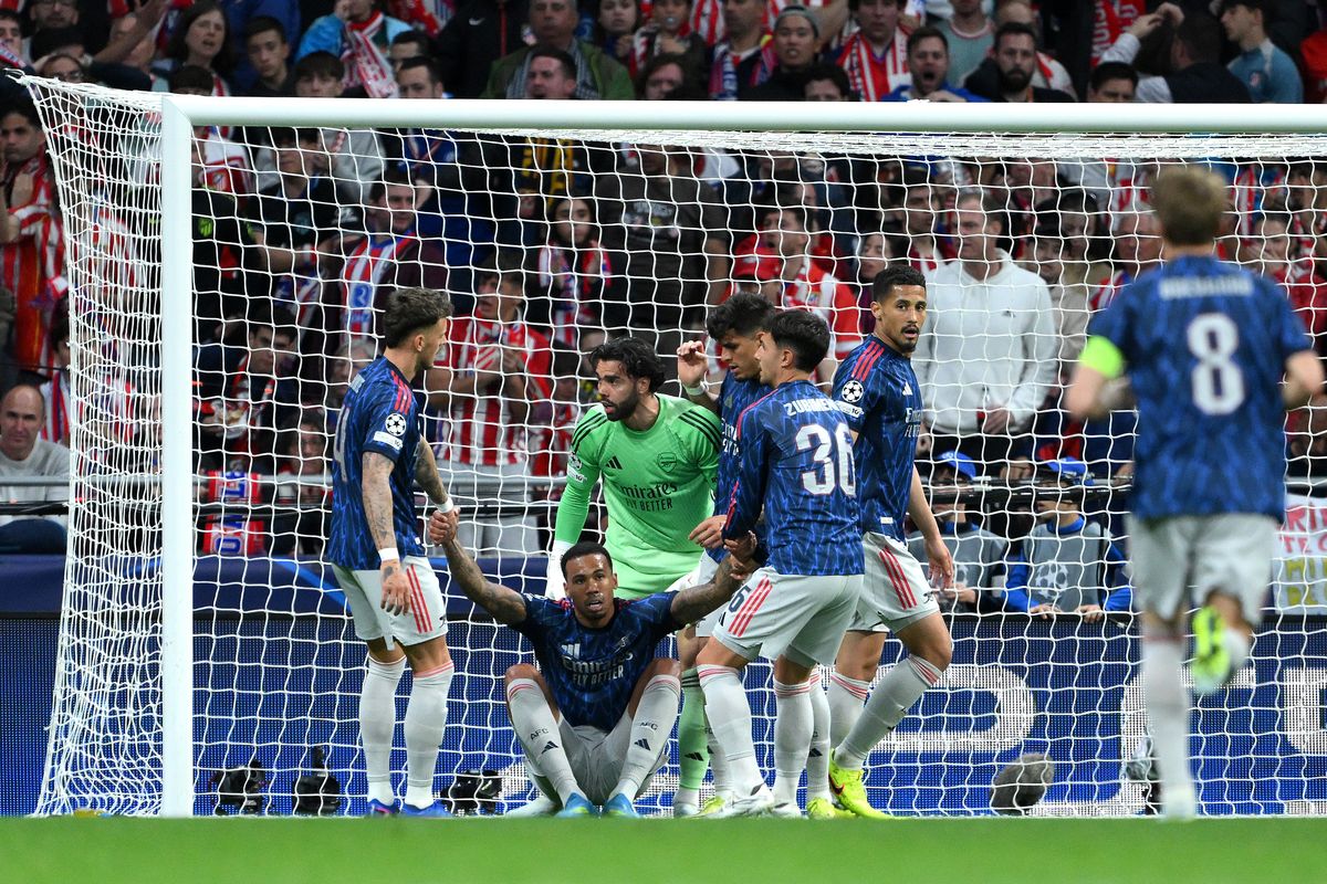 Gabriel of Arsenal is helped up by Ben White, David Raya, Piero Hincapie and Martin Zubimendi after blocking a shot from Antoine Griezmann