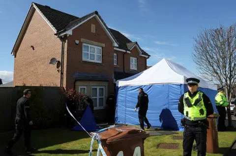 Reuters A blue police tent outside a modern house