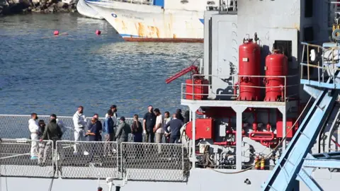EPA Migrants on an Italian navy ship arriving in Albania 
