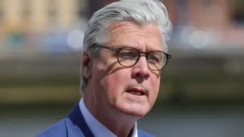 PA Media Malcolm Offord, who has grey hair and glasses, in a close-up shot 