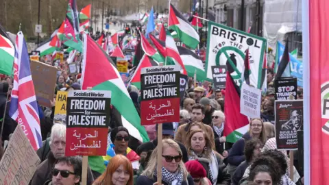 PA People take part in a Together for Palestine march organised by Palestine Coalition, in central London