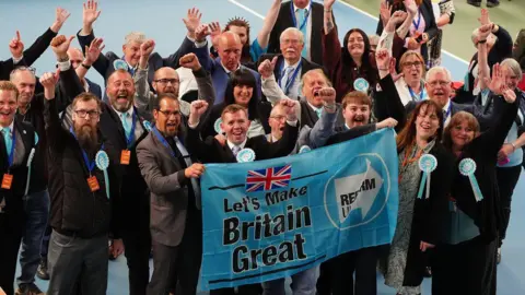 PA Media Reform UK supporters celebrate during the 2026 local election count at the Silksworth Sports Complex in Sunderland. Picture date: Friday May 8, 2026. PA Photo.