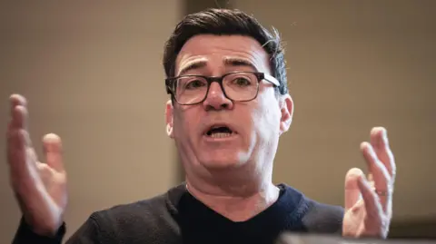 PA Media Andy Burnham in a dark jumper.