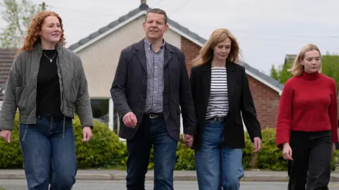 PA Media Rhun ap Iorwerth with an older woman and two younger women