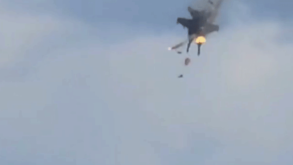 Two jets collide midair during the Gunfighter Skies Air Show near Mountain Home Air Force Base in Idaho as flames and debris fall from one aircraft.